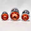 Primal Desires Metal Butt Plug with Jewel - Golden / Orange Set